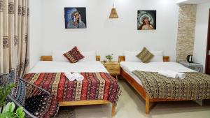 Postel nebo postele na pokoji v ubytování Hotel Làng Kò Hơ