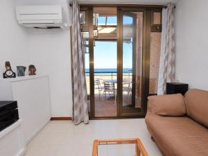 a living room with a couch and a view of the ocean at Apartment Tatiana by Interhome in Torredembarra