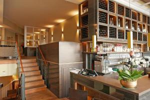 a bar in a restaurant with a counter and stairs at Arte Luise Kunsthotel in Berlin