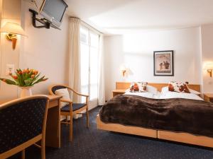 Ένα ή περισσότερα κρεβάτια σε δωμάτιο στο Hotel Oberland