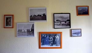 a group of pictures on a wall at Ferienzimmer unterm Reetdach in Pl in Neuendorf +16 photos