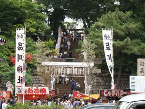 a crowd of people walking up a stairs with signs at Super Hotel Shinagawa Shinbanba in Tokyo