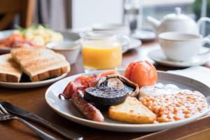 a plate of breakfast food on a wooden table at Judge's Lodging in York