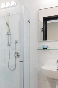 a bathroom with a shower and a sink at Blue Sea Marble in Tel Aviv