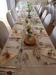 a long table with plates and silverware and flowers on it at Chase Hotel in Whitehaven