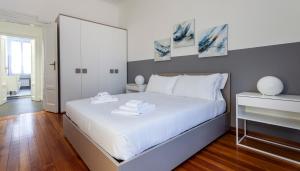 a bedroom with a large white bed with a mirror at Italianway - Napo Torriani 5 in Milan