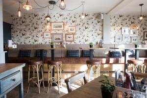 a restaurant with bar stools and a wall with pictures at Seacroft in Holyhead