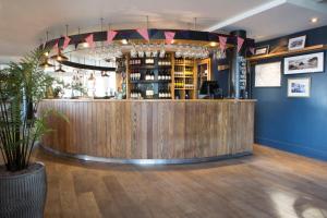 a bar in a restaurant with blue walls at Seacroft in Holyhead