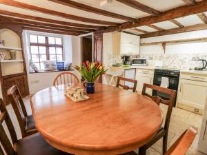 a dining room with a wooden table and chairs at Teign Cottage in Teignmouth