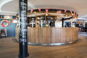 a bar with a sign in the middle of a room at Seacroft in Holyhead