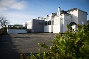 a large white building with a parking lot at Seacroft in Holyhead