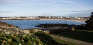 a large body of water with a beach and houses at Seacroft in Holyhead