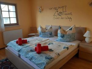 a bedroom with two beds with red pillows on them at Scharfer Kessel in Weimar