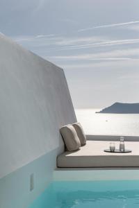 a bed with a view of the ocean on a boat at The Saint Hotel in Oia