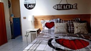 a bedroom with a bed with pillows and a sign on the wall at Attico mansardato davanti Casinò in Sanremo