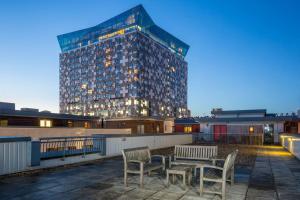 a building with two chairs and a table in front of it at City view apartment in Birmingham