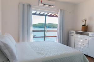 A bed or beds in a room at Casa Arraial do Cabo
