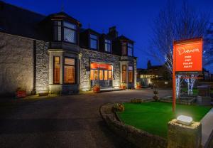 a house with a sign in front of it at The Dunavon in Dyce