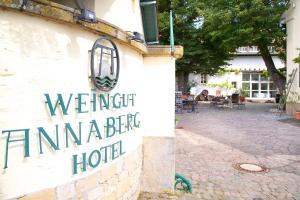 a sign for a hotel on the side of a building at Hotel Annaberg in Bad Dürkheim