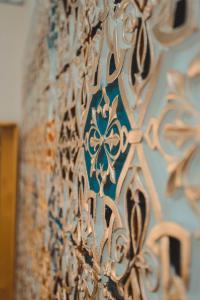a close up of a wall with intricate metal at Yasmin in Bukhara