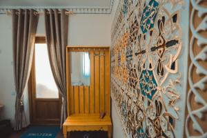 a room with a wall with a painting on it at Yasmin in Bukhara
