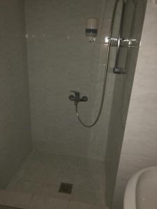 a shower with a glass door in a bathroom at The Pines in Skala