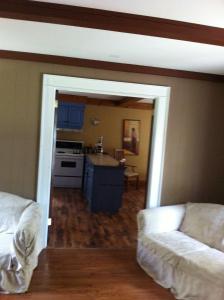 a living room with a couch and a kitchen at Seymour Point Cottage in Campbellford +3 photos