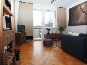 a living room with a couch and a television at Grand-Tourist Apartment - Gold in Gdańsk