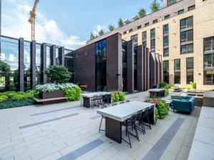 a patio with tables and chairs in front of a building at Global Luxury Suites at Reston Town Center in Reston
