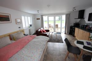 a bedroom with a bed and a living room at Lynton Lodge Studios in Keswick