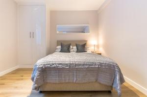 a bedroom with a large bed with two pillows at Chelsea Cloisters in London