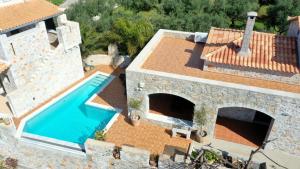 an aerial view of a house with a swimming pool at Mani Stone Towers in Kotrónion