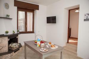 uma sala de estar com uma mesa e uma lareira em Cor Mij em Gragnano