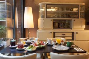 a dining room table with breakfast foods on it at Hotel Diamonds and Pearls in Antwerp