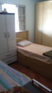 a bedroom with two twin beds and a dresser at Aconchego dos schreiber in Belo Horizonte