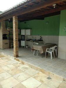 a large patio with a table and a kitchen at LINDO SOBRADO COM PISCINA PARA ATÉ 10 HÓSPEDES! in Natal