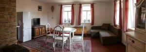 a living room with a table and a couch at Chalupy Březka in Libuň