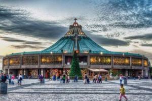 a large building with a christmas tree in front of it at San Ángel - UNAM apartment 2parking 3BR 2BA in Mexico City