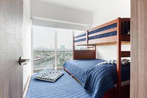 a bedroom with two bunk beds and a large window at San Ángel - UNAM apartment 2parking 3BR 2BA in Mexico City