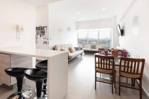 a kitchen and living room with a table and chairs at San Ángel - UNAM apartment 2parking 3BR 2BA in Mexico City