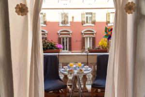 a table with food and drinks on top of a balcony at Hotel Sol Levante in Rome