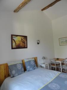 a bedroom with a bed and a table at Ferme Passion in Saint-Trivier-sur-Moignans