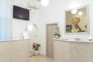 a hotel lobby with a reception desk and a mirror at Hotel Sol Levante in Rome