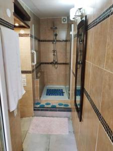 a small bathroom with a shower with a tub at Sweet Home Suite in Korinthos