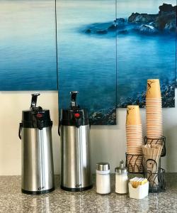 a couple of kettles sitting on top of a counter at Sea-Tac Airport Value Inn in SeaTac