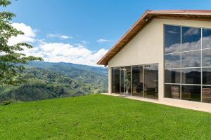 a house on top of a hill with a view at Casa Sofia, a Gem Close to Orosi Thermal Pools! in Orosí