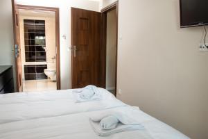 Posteľ alebo postele v izbe v ubytovaní APARTAMENT PERŁA A11 NAD PIĘKNYM JEZIOREM PLUSZNE
