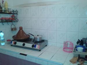 a kitchen with a stove with a tea kettle on it at Takad Dream Rural in Takate