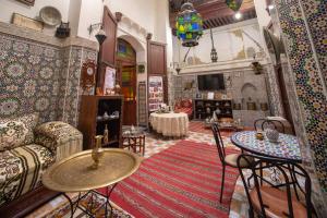 a living room with a couch and a table at Maison Famille Tazi in Fez