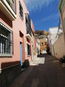 an alley in a town with pink buildings at Bella Vista in Almería